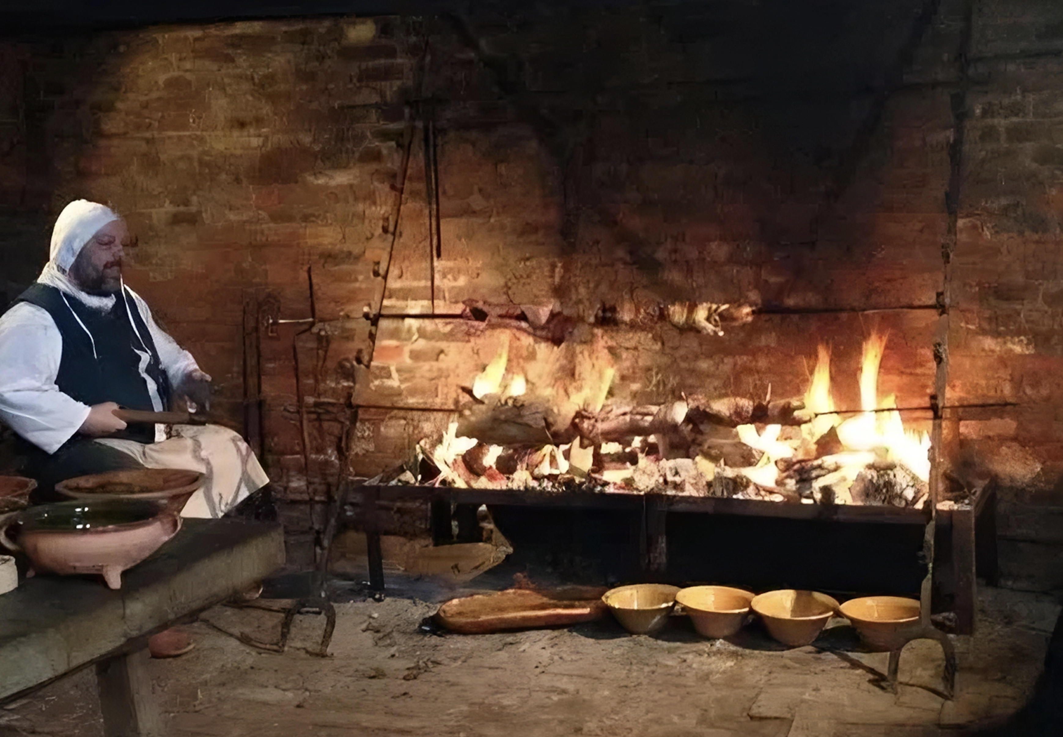 Asando en una chimenea de castillo con espetones manuales